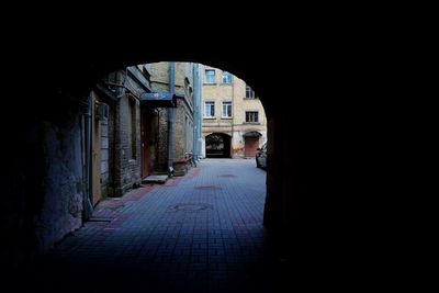 Empty alley amidst buildings in city