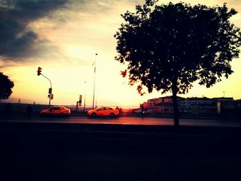 Cars on road at sunset