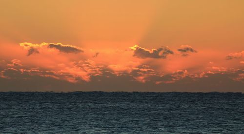 Scenic view of sea against orange sky