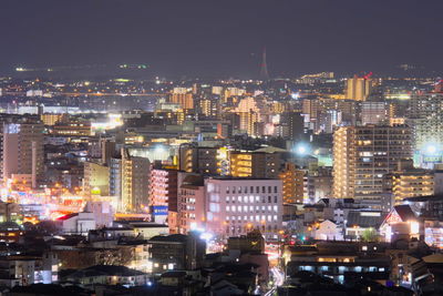 Aerial view of city lit up at night