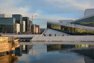 Bridge over river against buildings in city