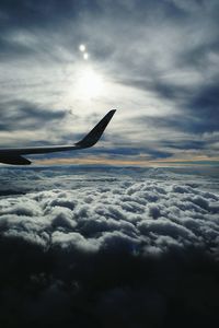 Airplane flying over cloudy sky