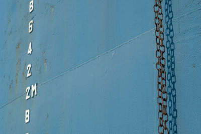 Full frame shot of metallic structure against blue wall