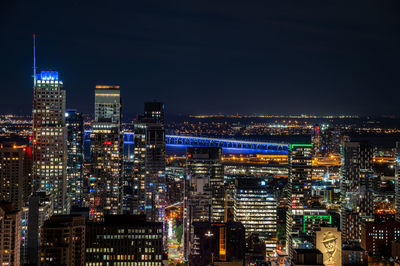 Illuminated cityscape against sky at night