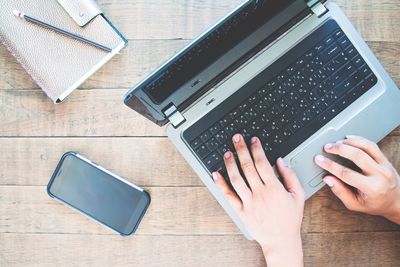 High angle view of man using laptop on table