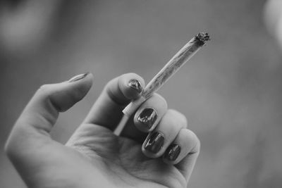 Close-up of woman hand holding cigarette