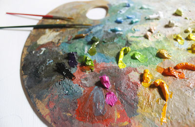 High angle view of multi colored paint on palette