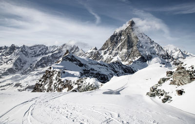 Scenic view of snow covered mountains against sky