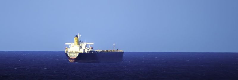 View of boats in sea against clear sky