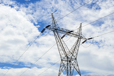 Low angle view of electricity pylon against sky