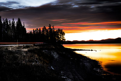 Scenic view of lake against orange sky