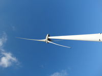 Low angle view of windmill against blue sky