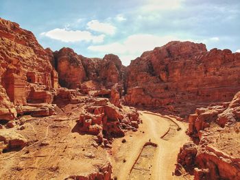 Scenic view of rocky mountains against cloudy sky