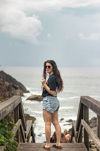 A young girl near the beach on a cloudy day.