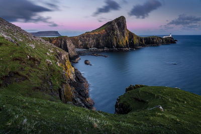 Scenic view of lighthouse, sea and mountains against sky