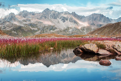 Scenic view of lake and mountains against sky