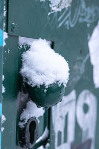 Close-up of snow on metal door