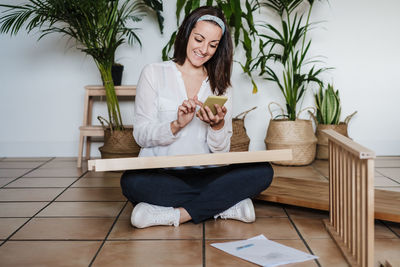 Woman sitting on chair at home