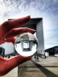 Close-up of hand holding crystal ball