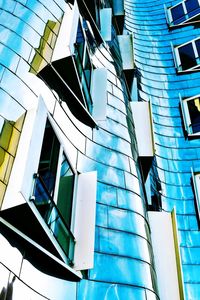 Low angle view of modern building against blue sky