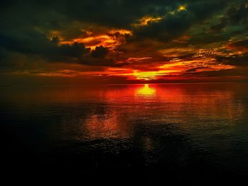 Scenic view of sea against romantic sky at sunset