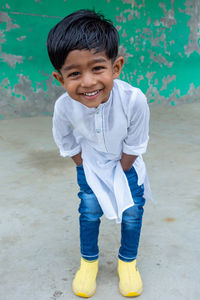 Portrait of smiling boy standing outdoors