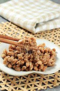 Close up natto fermented soybean with stinky smell. japanese healthy traditional food. lift natto