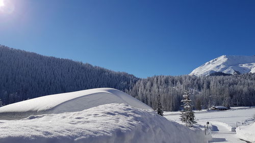 Scenic view of snowcapped mountains against clear blue sky