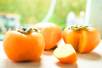 Close-up of persimmons on table