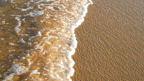 High angle view of waves rushing towards shore