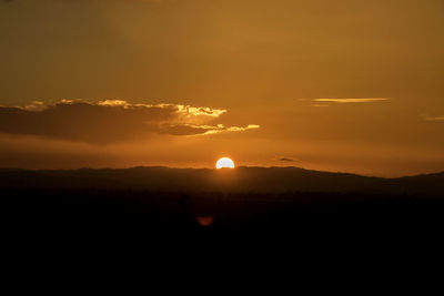 Scenic view of silhouette landscape against sky during sunset