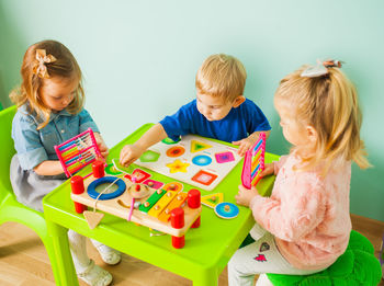 High angle view of children playing with toy