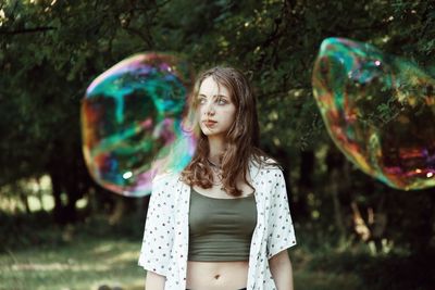 Full length of a beautiful young woman with bubbles