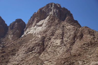 Low angle view of rock formations against sky