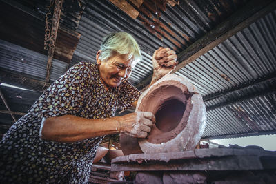 Senior woman working at workshop