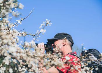 Low angle view of man against blue sky