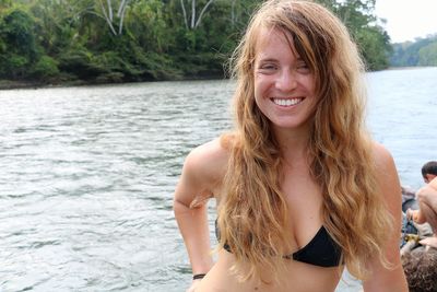 Portrait of smiling young woman in lake