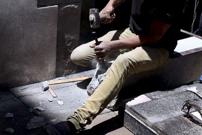 Low section of man working on concrete