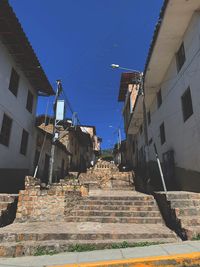 Low angle view of old buildings against clear blue sky