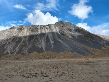 Scenic view of volcanic landscape against sky 