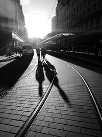 People walking on street amidst buildings in city