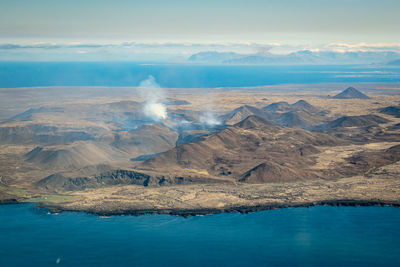 Aerial view of sea and mountain against sky