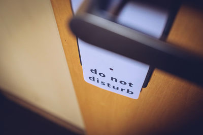 High angle view of do not disturb sign hanging on door