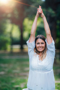 Yoga woman, grounding in nature, tree pose, green background.