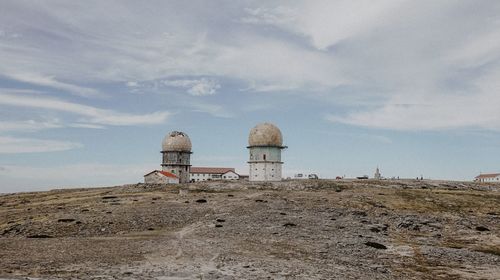 Built structure on beach against sky