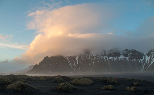 Scenic view of snowcapped mountains against sky during sunset