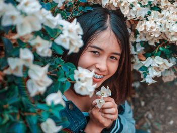 Portrait of smiling girl with flowers