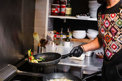 Midsection of woman preparing food at home