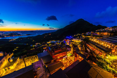 High angle view of illuminated cityscape against sky