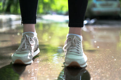 Low section of man standing in water